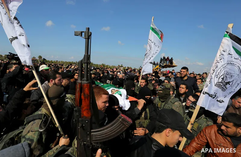 Palestinian militants from the Ezzedine al-Qassam Brigades, the armed wing of the Hamas movement carry the body of Hamas senior leader Imad al-Alami during his funeral in Gaza City on January 30, 2018. A senior Hamas off...