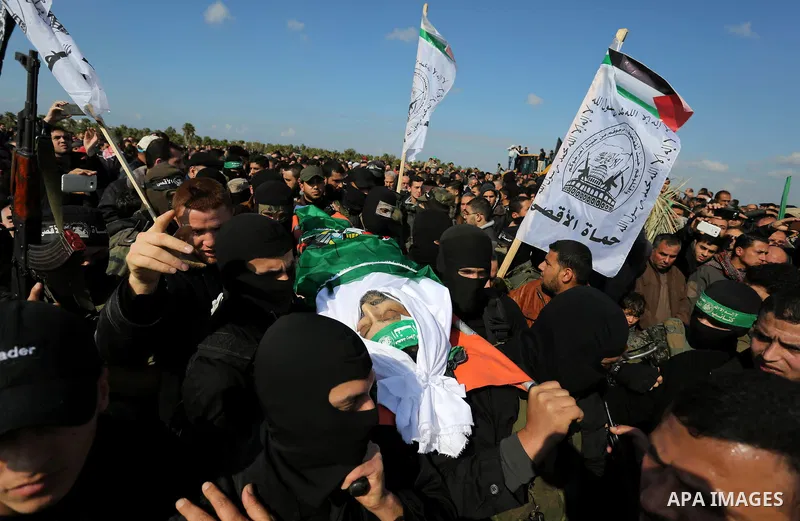 Palestinian militants from the Ezzedine al-Qassam Brigades, the armed wing of the Hamas movement carry the body of Hamas senior leader Imad al-Alami during his funeral in Gaza City on January 30, 2018. A senior Hamas off...