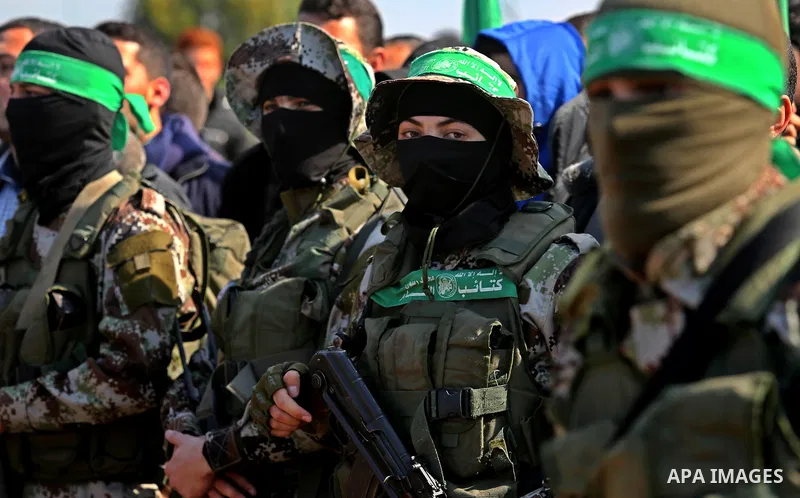 Palestinian militants from the Ezzedine al-Qassam Brigades, the armed wing of the Hamas movement attend the funeral of Hamas senior leader Imad al-Alami in Gaza City on January 30, 2018. A senior Hamas official has died...