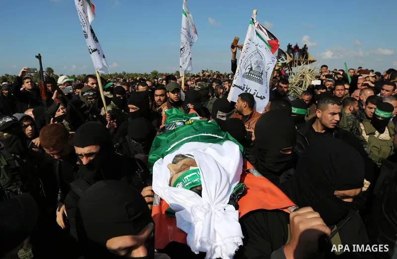 Palestinian militants from the Ezzedine al-Qassam Brigades, the armed wing of the Hamas movement carry the body of Hamas senior leader Imad al-Alami during his funeral in Gaza City on January 30, 2018. A senior Hamas off...