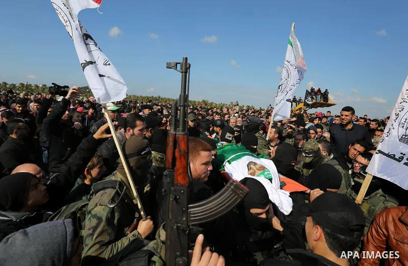 Palestinian militants from the Ezzedine al-Qassam Brigades, the armed wing of the Hamas movement carry the body of Hamas senior leader Imad al-Alami during his funeral in Gaza City on January 30, 2018. A senior Hamas off...