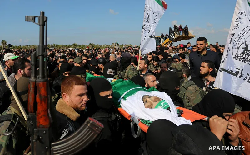 Palestinian militants from the Ezzedine al-Qassam Brigades, the armed wing of the Hamas movement carry the body of Hamas senior leader Imad al-Alami during his funeral in Gaza City on January 30, 2018. A senior Hamas off...