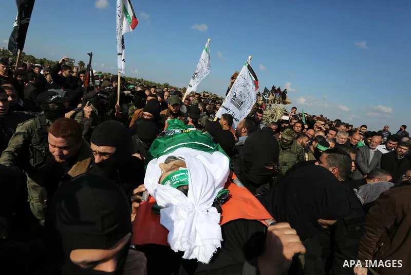Palestinian militants from the Ezzedine al-Qassam Brigades, the armed wing of the Hamas movement carry the body of Hamas senior leader Imad al-Alami during his funeral in Gaza City on January 30, 2018. A senior Hamas off...