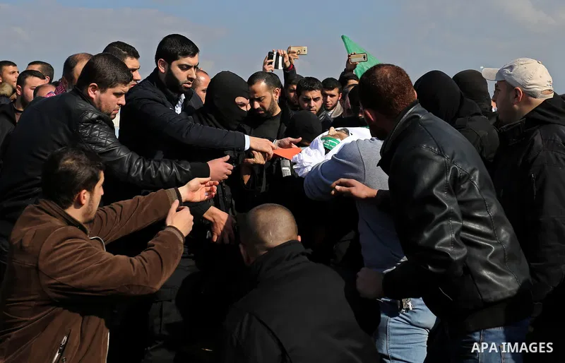 Palestinian militants from the Ezzedine al-Qassam Brigades, the armed wing of the Hamas movement carry the body of Hamas senior leader Imad al-Alami during his funeral in Gaza City on January 30, 2018. A senior Hamas off...