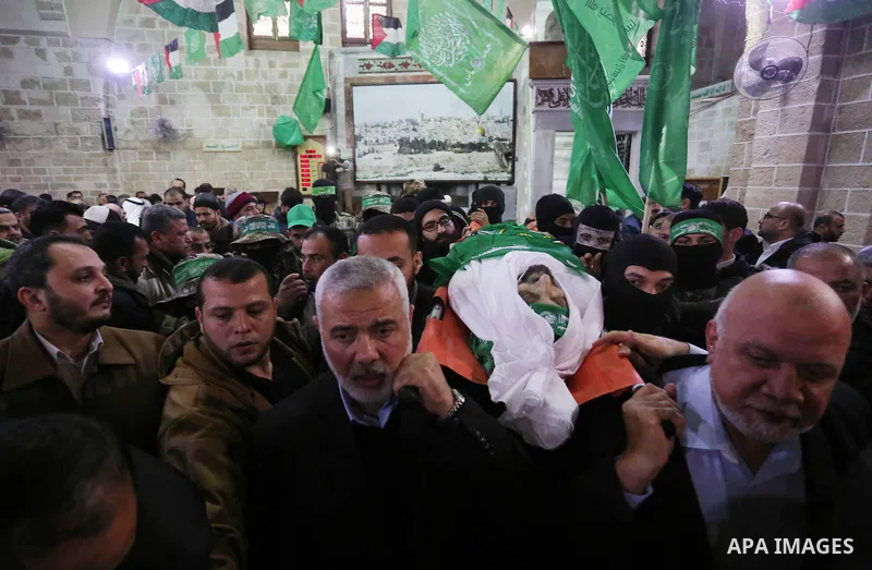 Hamas Chief Ismail Haniyeh carries the body of Hamas senior official Imad al-Alami during his funeral at the al-Omari mosque in Gaza City on January 30, 2018. A senior Hamas official has died in Gaza three weeks after sh...