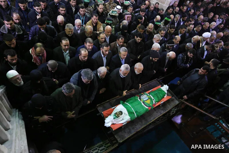 Palestinian mourners pray over the body of Hamas senior leader Imad al-Alami during his funeral at the al-Omari mosque in Gaza City on January 30, 2018. A senior Hamas official has died in Gaza three weeks after shooting...
