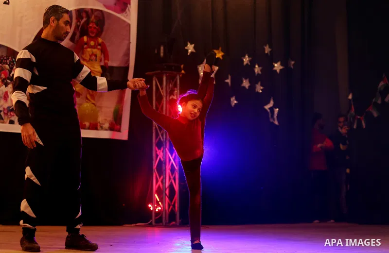 A Palestinian girl demonstrates her acrobatics skills during a "joy and fun" festival for Palestinian school students which organized by Gaza Municipality in Gaza city on January 30, 2018. Photo by Ashraf Amra