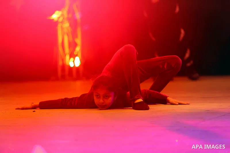 A Palestinian girl demonstrates her acrobatics skills during a "joy and fun" festival for Palestinian school students which organized by Gaza Municipality in Gaza city on January 30, 2018. Photo by Ashraf Amra