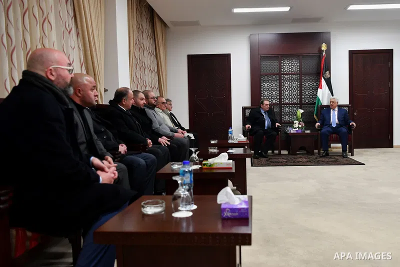 Palestinian President Mahmoud Abbas meets with the family of Ghassan Shakaa, a member of the Executive Committee of the PLO at his headquarters in the West Bank city of Ramallah on January 30, 2018. Photo by Osama Falah