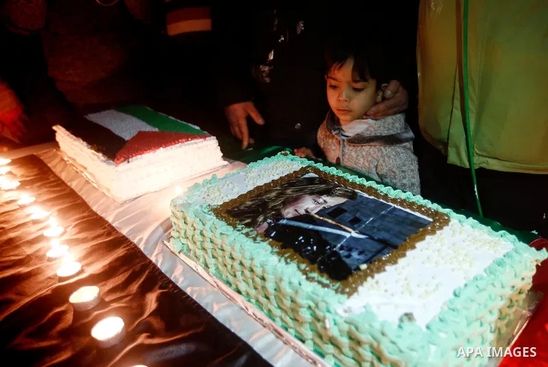 Palestinians take part in a symbolic birthday party for Palestinian teen Ahed Tamimi, who is detained by Israel, in the West Bank city of Hebron January 30, 2018. Photo by Wisam Hashlamoun