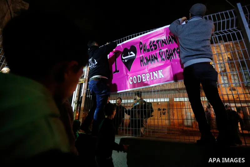 Palestinians hang posters in a symbolic birthday party for Palestinian teen Ahed Tamimi, who is detained by Israel, in the West Bank city of Hebron January 30, 2018. Photo by Wisam Hashlamoun