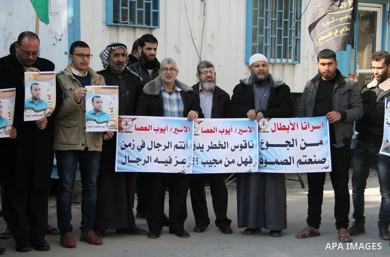 Palestinians take part in a protest to show solidarity with Ayoub el-Assa, who is hunger strike in Israeli jails, in front of the high commissioner for human rights headquarters, in Gaza city on January 31, 2018. Photo b...