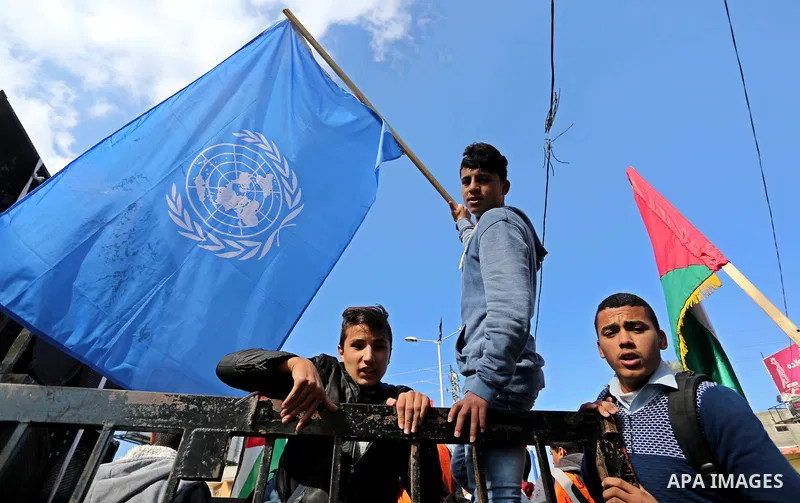Palestinian school students shout slogans and hold placards in a protest against the US move to freeze funding for the UN agency for Palestinian refugees on January 31, 2018 at the al-Nusairat refugee camp, in central Ga...
