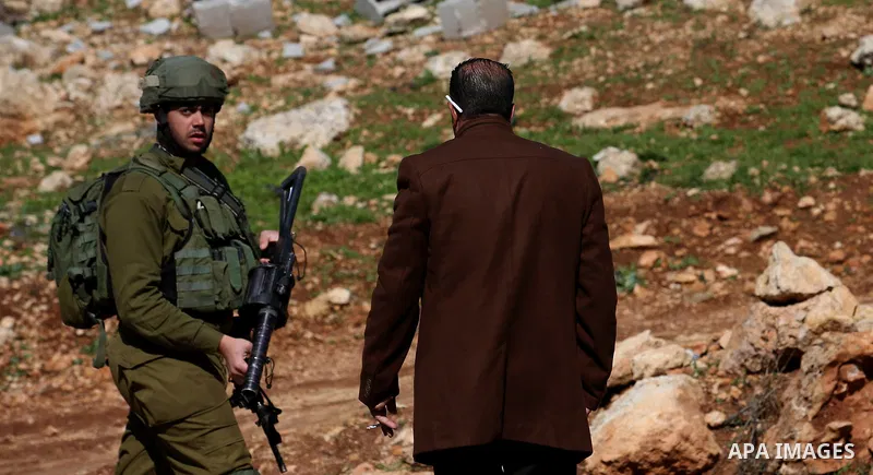 An Israeli security force stands guard as bulldozer demolish house which Israeli authorities said it was built without a permit during attempt to demolish it, at village of Beit Dajan, east of the West Bank city of Nablu...