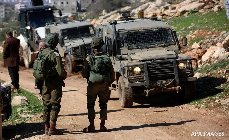 Israeli security forces stand guard as bulldozer demolish house which Israeli authorities said it was built without a permit during attempt to demolish it, at village of Beit Dajan, east of the West Bank city of Nablus o...