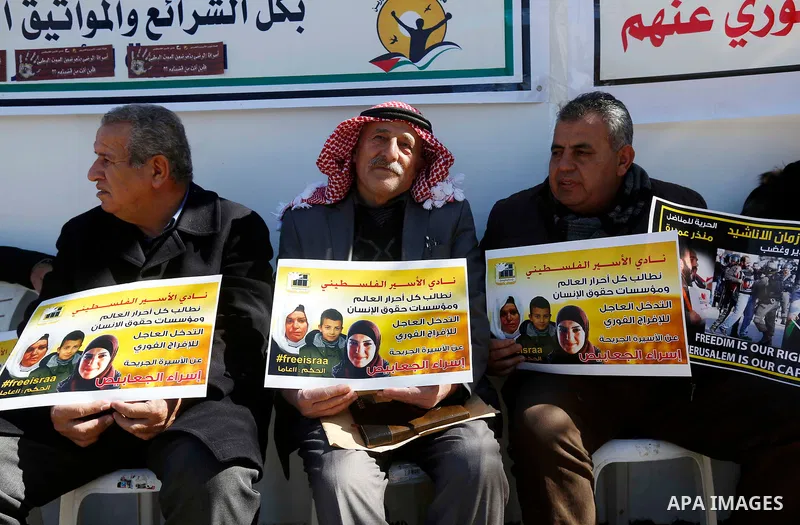 Palestinians take part in a protest of solidarity with prisoner Esraa Al-Jabbais held in Israeli jails in front of Red cross office, in the West Bank city of Hebron, on February 1, 2018. Photo by Wisam Hashlamoun