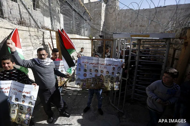 Palestinian protesters take part in a demonstration to mark the 24th anniversary of Ibrahimi mosque massacre when Baruch Goldstein an Israeli settler opened fire and killing 29 Palestinian worshipers On February 25, 1994...