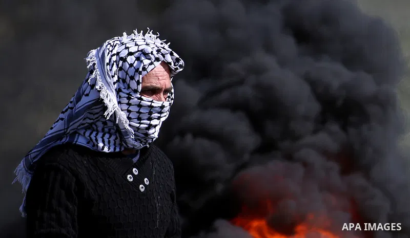 A Palestinian protester looks on during clashes with Israeli security forces following a weekly demonstration against the expropriation of Palestinian land by Israel in the village of Kfar Qaddum, near Nablus, in the occ...