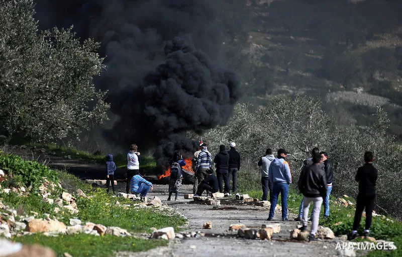 Palestinian protesters hurl stones towards Israeli security forces during clashes following a weekly demonstration against the expropriation of Palestinian land by Israel in the village of Kfar Qaddum, near Nablus, in th...