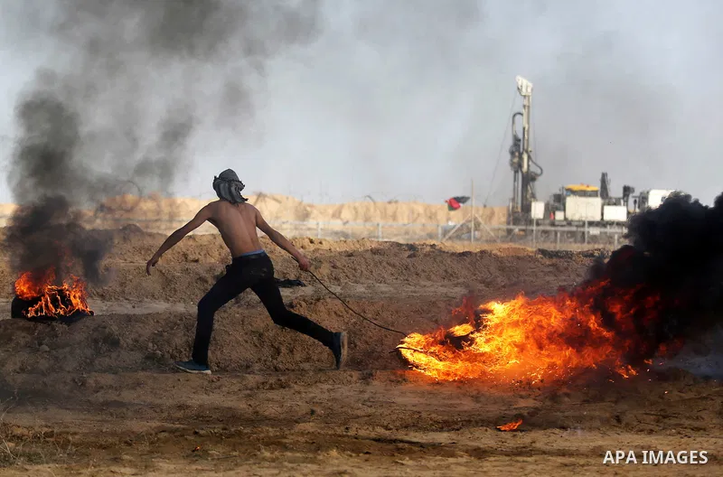 Palestinian protesters clash with Israeli security forces, against US President Donald Trump's decision to recognise Jerusalem as the capital of Israel, near the border with Israel in the southern Gaza Strip on February...