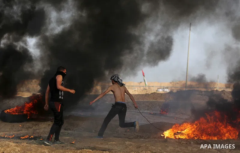 Palestinian protesters clash with Israeli security forces, against US President Donald Trump's decision to recognise Jerusalem as the capital of Israel, near the border with Israel in the southern Gaza Strip on February...