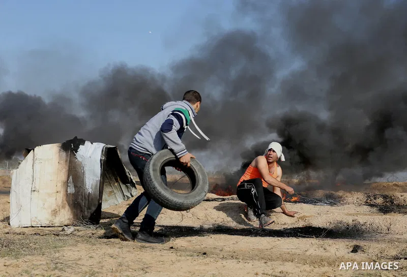 Palestinian protesters clash with Israeli security forces, against US President Donald Trump's decision to recognise Jerusalem as the capital of Israel, near the border with Israel in the southern Gaza Strip on February...