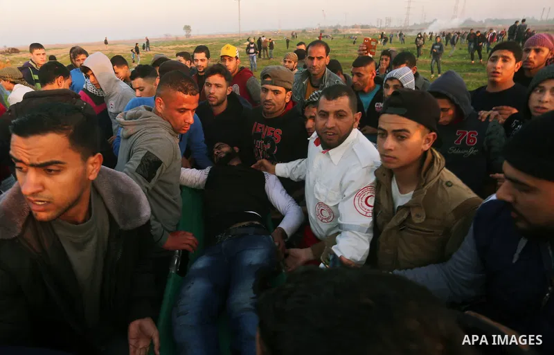 A wounded Palestinian protester is evacuated during clashes with Israeli security forces, near the border with Israel, east of Gaza City on February 2, 2018. Photo by Yasser Qudih