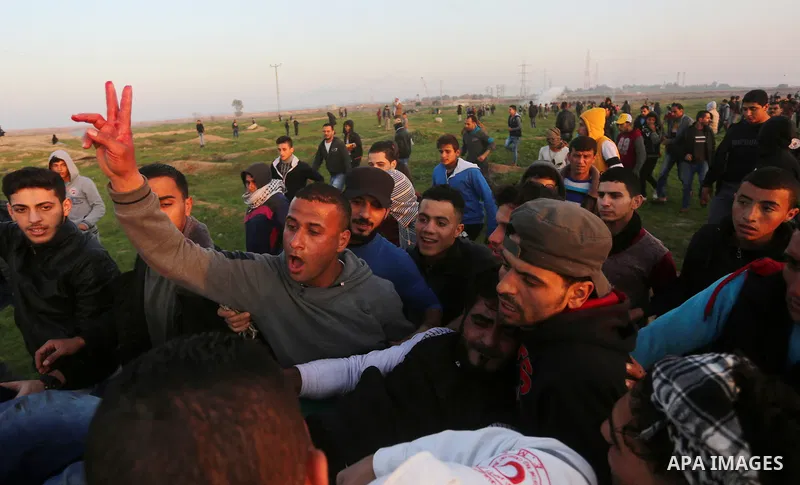 A wounded Palestinian protester is evacuated during clashes with Israeli security forces, near the border with Israel, east of Gaza City on February 2, 2018. Photo by Yasser Qudih