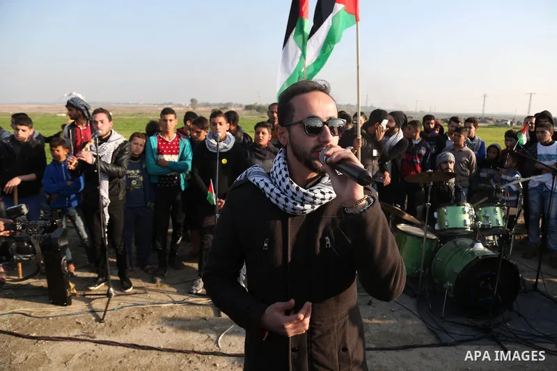 A Palestinian band performs a concert during clashes near the border with Israel, east of Gaza City on February 2, 2018. Photo by Yasser Qudih