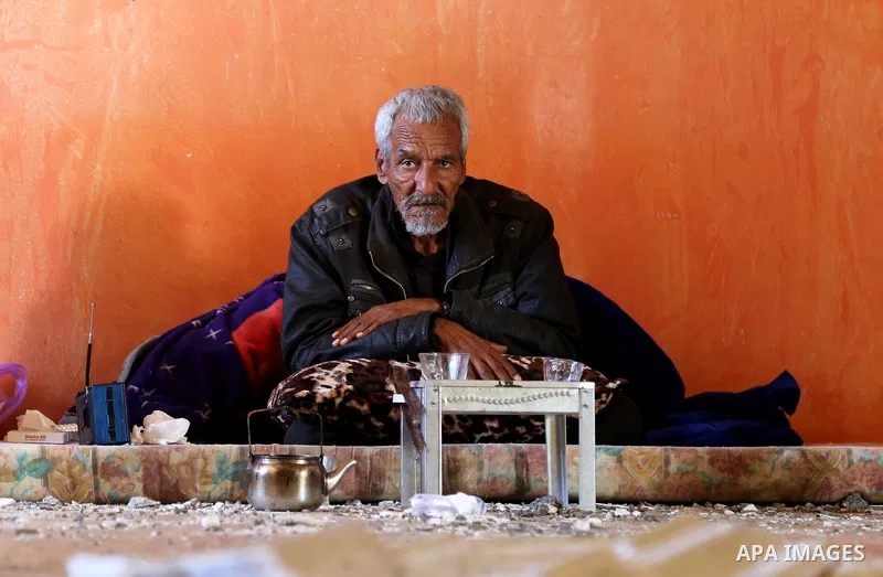 An elderly Palestinian man sits inside his apartment which was damaged after an attack carried out by the Israeli army in Beit Hanun in the northern Gaza Strip on February 2, 2018. Israeli forces struck a Hamas position...