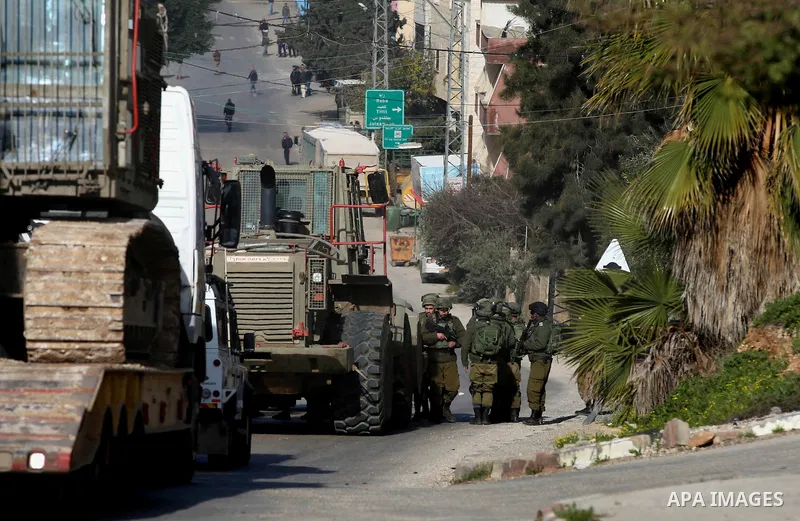 Israeli security forces take position during a search operation for Palestinians suspected of carrying out attacks in the West Bank village of Zababdeh, north of Jenin on February 3, 2018. Photo by Ayman Ameen