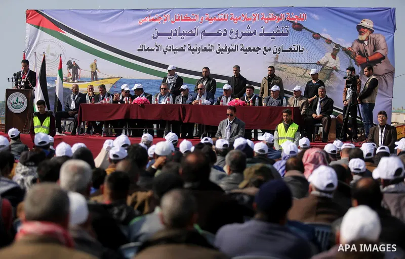 Palestinian fishermen attend a ceremony of support Palestinian fishermen project funded by the national islamic committee for development and social solidarity, in Gaza sea port on February 3, 2018. Photo by Ashraf Amra
