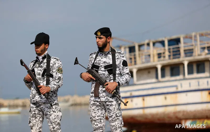 Palestinian security forces stand guard during a ceremony of support Palestinian fishermen project funded by the national islamic committee for development and social solidarity, in Gaza sea port on February 3, 2018. Pho...
