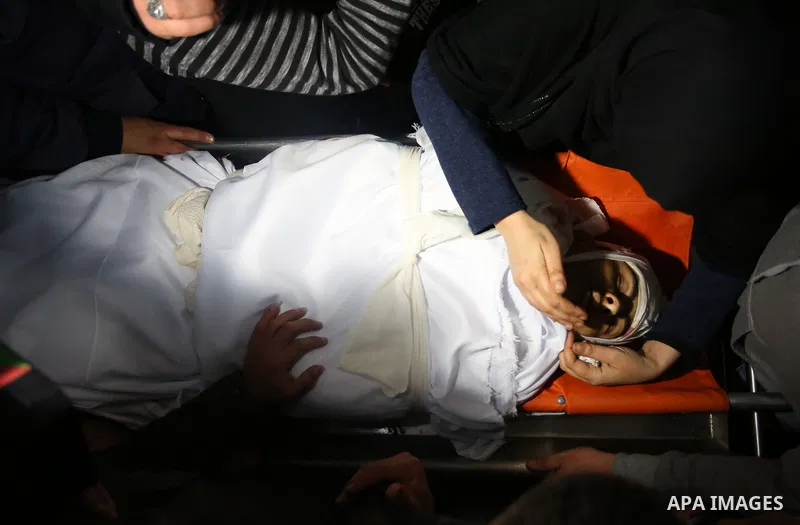 Relatives of Palestinian Ahmed Abu Obeid, 19, who was shot dead during clashes with Israeli security foces mourn over his body at a hospital morgue, in the West Bank city of Jenin, on February. 03, 2018. Photo by Shadi J...