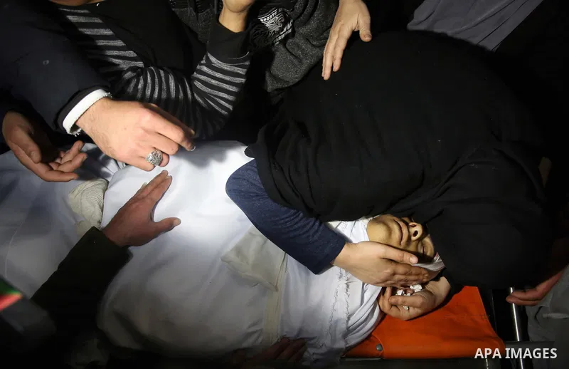 Relatives of Palestinian Ahmed Abu Obeid, 19, who was shot dead during clashes with Israeli security foces mourn over his body at a hospital morgue, in the West Bank city of Jenin, on February. 03, 2018. Photo by Shadi J...