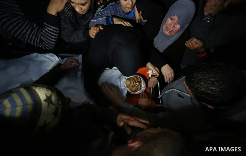 Relatives of Palestinian Ahmed Abu Obeid, 19, who was shot dead during clashes with Israeli security foces mourn over his body at a hospital morgue, in the West Bank city of Jenin, on February. 03, 2018. Photo by Shadi J...