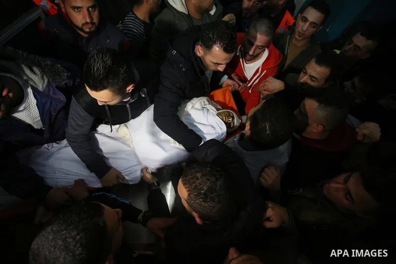 Relatives of Palestinian Ahmed Abu Obeid, 19, who was shot dead during clashes with Israeli security foces mourn over his body at a hospital morgue, in the West Bank city of Jenin, on February. 03, 2018. Photo by Shadi J...