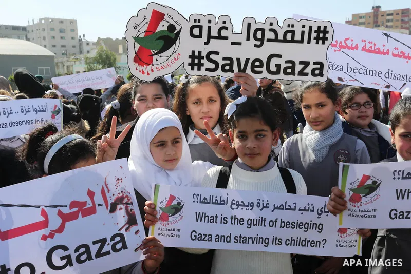 Palestinian students hold banners during a protest against Israeli blockade on Gaza strip, in Gaza city on February 4, 2018. Photo by Ashraf Amra
