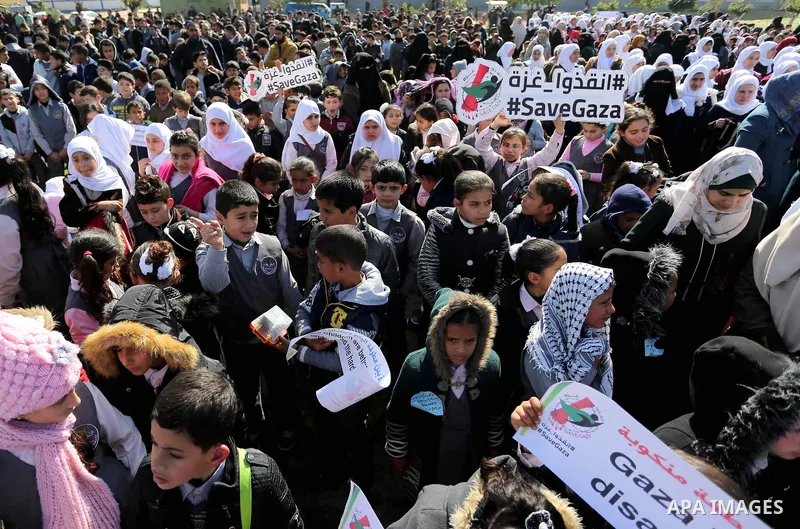Palestinian students hold banners during a protest against Israeli blockade on Gaza strip, in Gaza city on February 4, 2018. Photo by Ashraf Amra