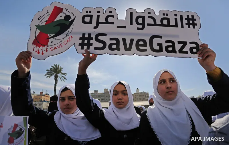 Palestinian students hold banners during a protest against Israeli blockade on Gaza strip, in Gaza city on February 4, 2018. Photo by Ashraf Amra