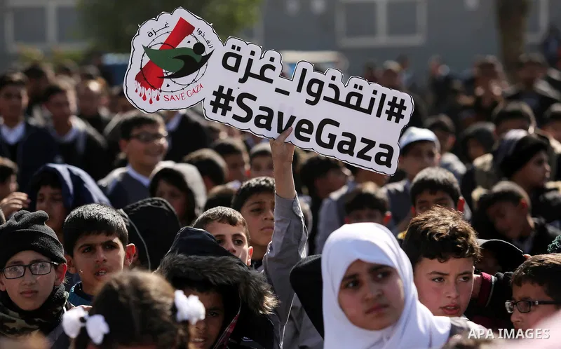 Palestinian students hold banners during a protest against Israeli blockade on Gaza strip, in Gaza city on February 4, 2018. Photo by Ashraf Amra