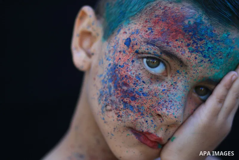 A portrait of a boy with colored face. Photo by Sanad Ltefa
