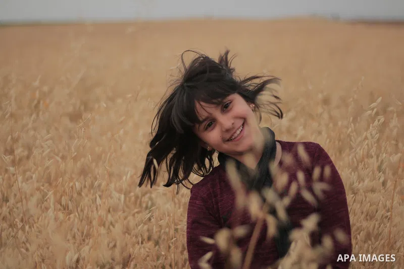 Hair flip of a young girl calling the nature. Photo by Sanad Ltefa