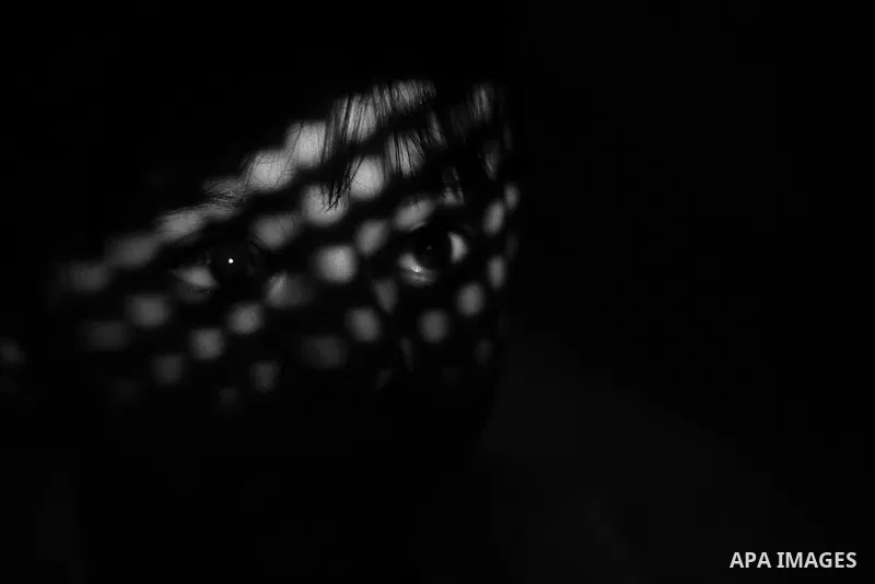 Close up of a little girl face illuminated through a window blind, Focus on the eye, High contrast, black and white. Photo by Sanad Ltefa
