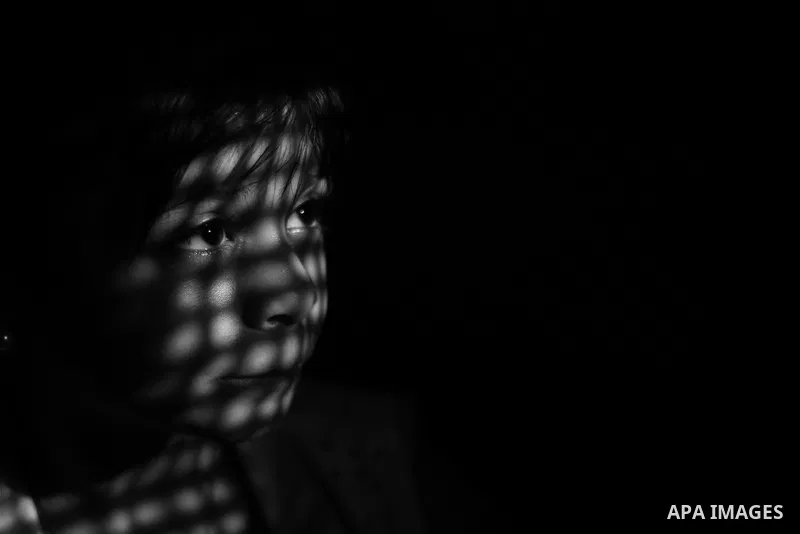 Close up of a little girl face illuminated through a window blind, Focus on the eye, High contrast, black and white. Photo by Sanad Ltefa