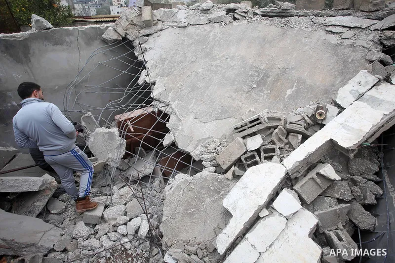 Palestinians check the damage where Israeli forces killed Palestinian gunman Ahmad Nasr Jarrar in Yamoun in the occupied West Bank, February 6, 2018. Photo by Ayman Ameen