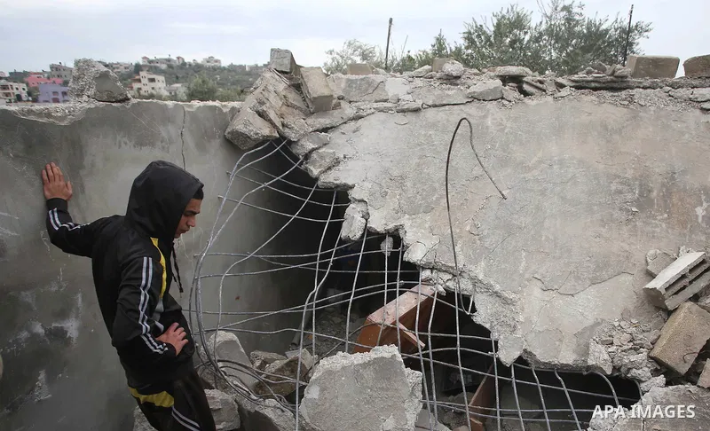 Palestinians check the damage where Israeli forces killed Palestinian gunman Ahmad Nasr Jarrar in Yamoun in the occupied West Bank, February 6, 2018. Photo by Ayman Ameen
