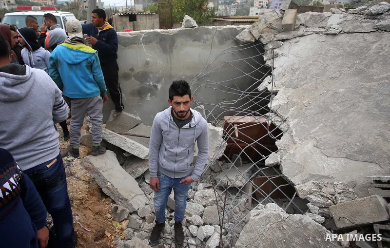 Palestinians check the damage where Israeli forces killed Palestinian gunman Ahmad Nasr Jarrar in Yamoun in the occupied West Bank, February 6, 2018. Photo by Ayman Ameen