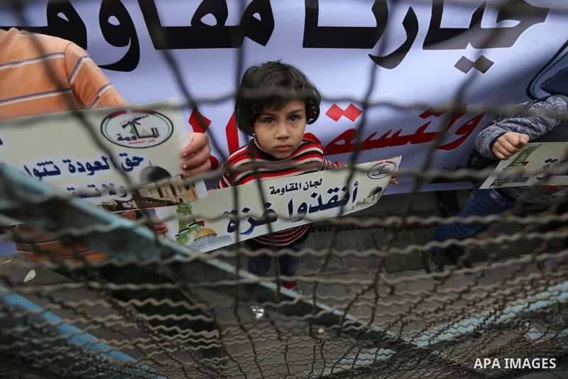 Palestinians take part in a protest against the US move to freeze funding for the UN agency for Palestinian refugees in the southern Gaza Strip town of Rafah on February 6, 2018. Photo by Ashraf Amra