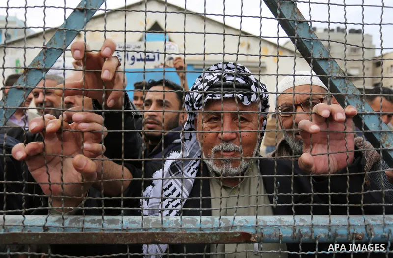 Palestinians take part in a protest against the US move to freeze funding for the UN agency for Palestinian refugees in the southern Gaza Strip town of Rafah on February 6, 2018. Photo by Ashraf Amra